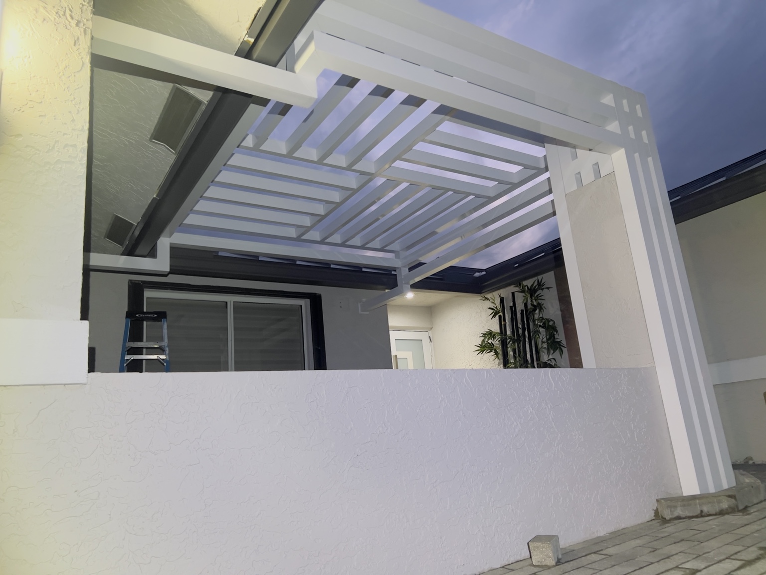 Wide evening view of the completed pergola